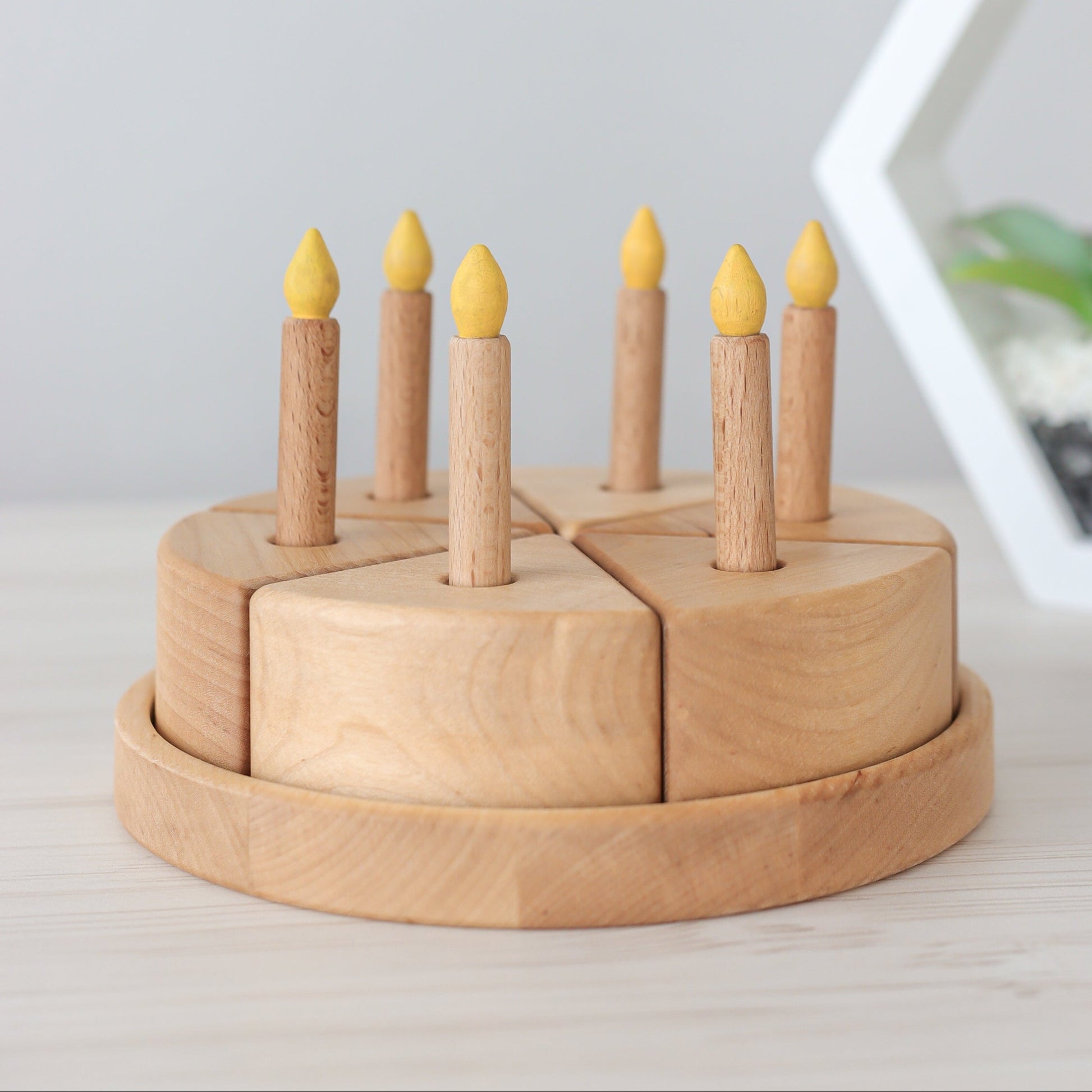 Wooden birthday cake with candles